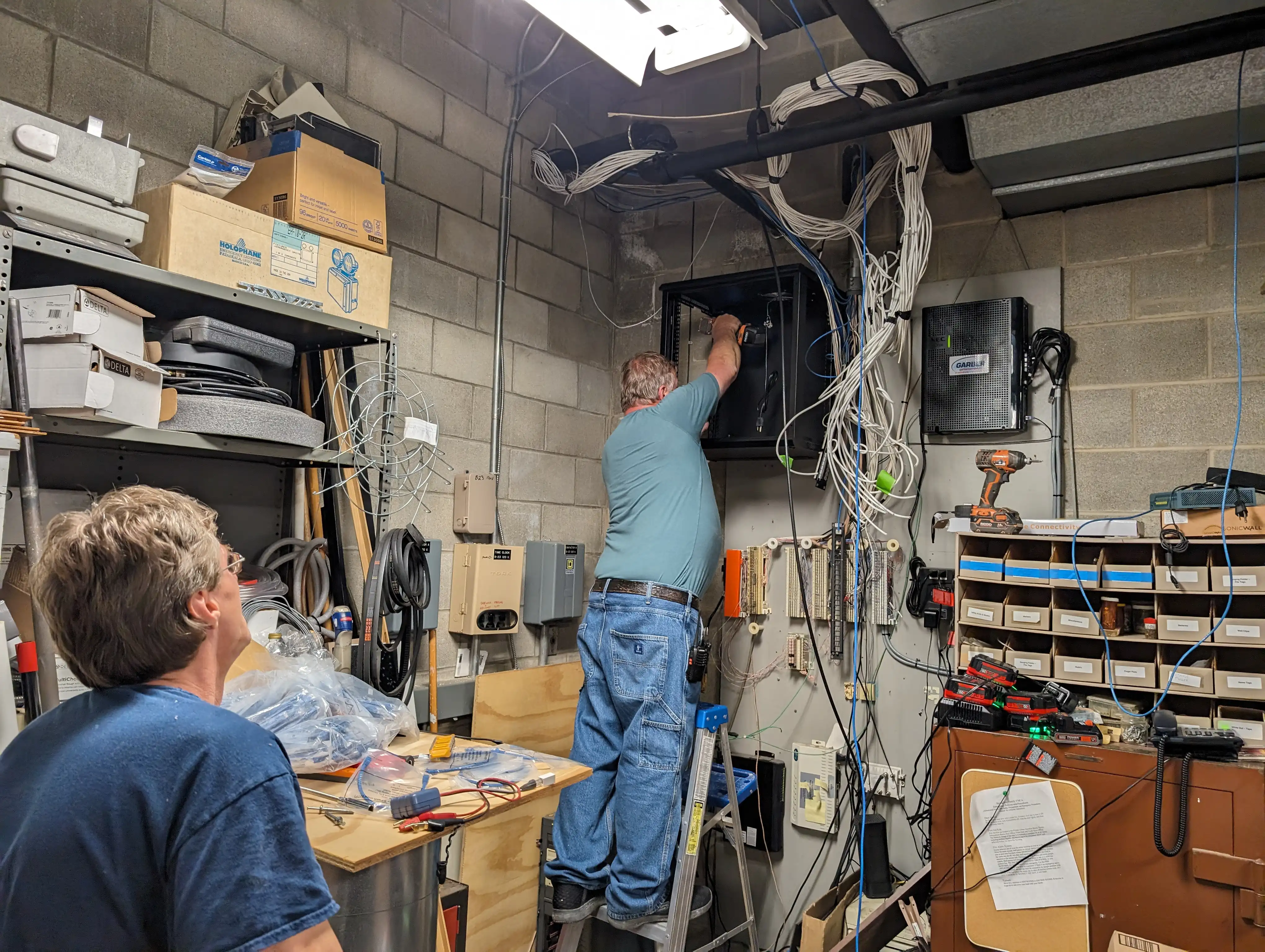 Installation crew working through ceiling pathways installing Cat6 structured cabling at Springfield Family YMCA gymnasium